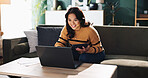 Laptop, remote work and woman in home for accounting, budget review and bookkeeping on tablet. Technology, sofa and happy freelancer on app for financial audit, communication and taxes on internet