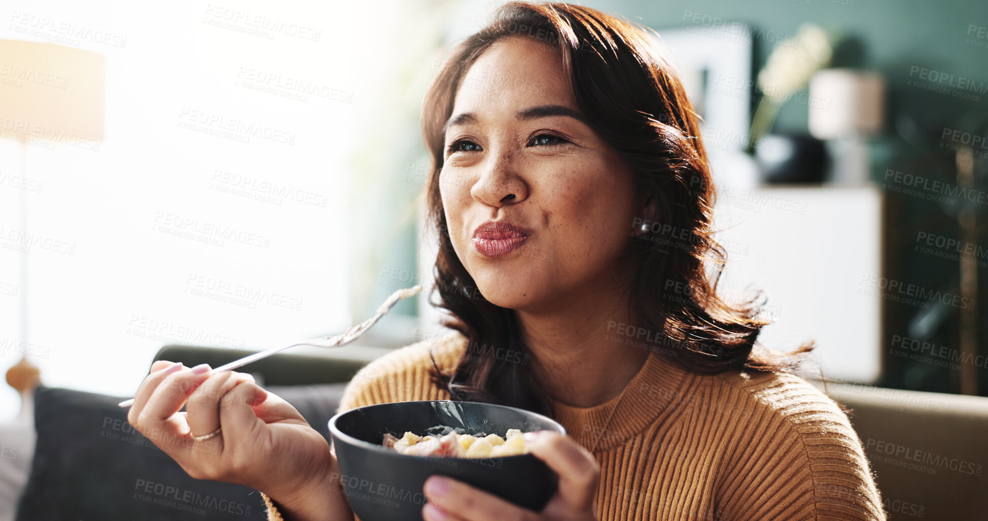 Buy stock photo Happy, woman and eating food on sofa for dinner meal, nutrition and enjoyment with relax. Wellness snack, person and hungry with pasta bowl in living room for healthy diet, weekend break and cuisine