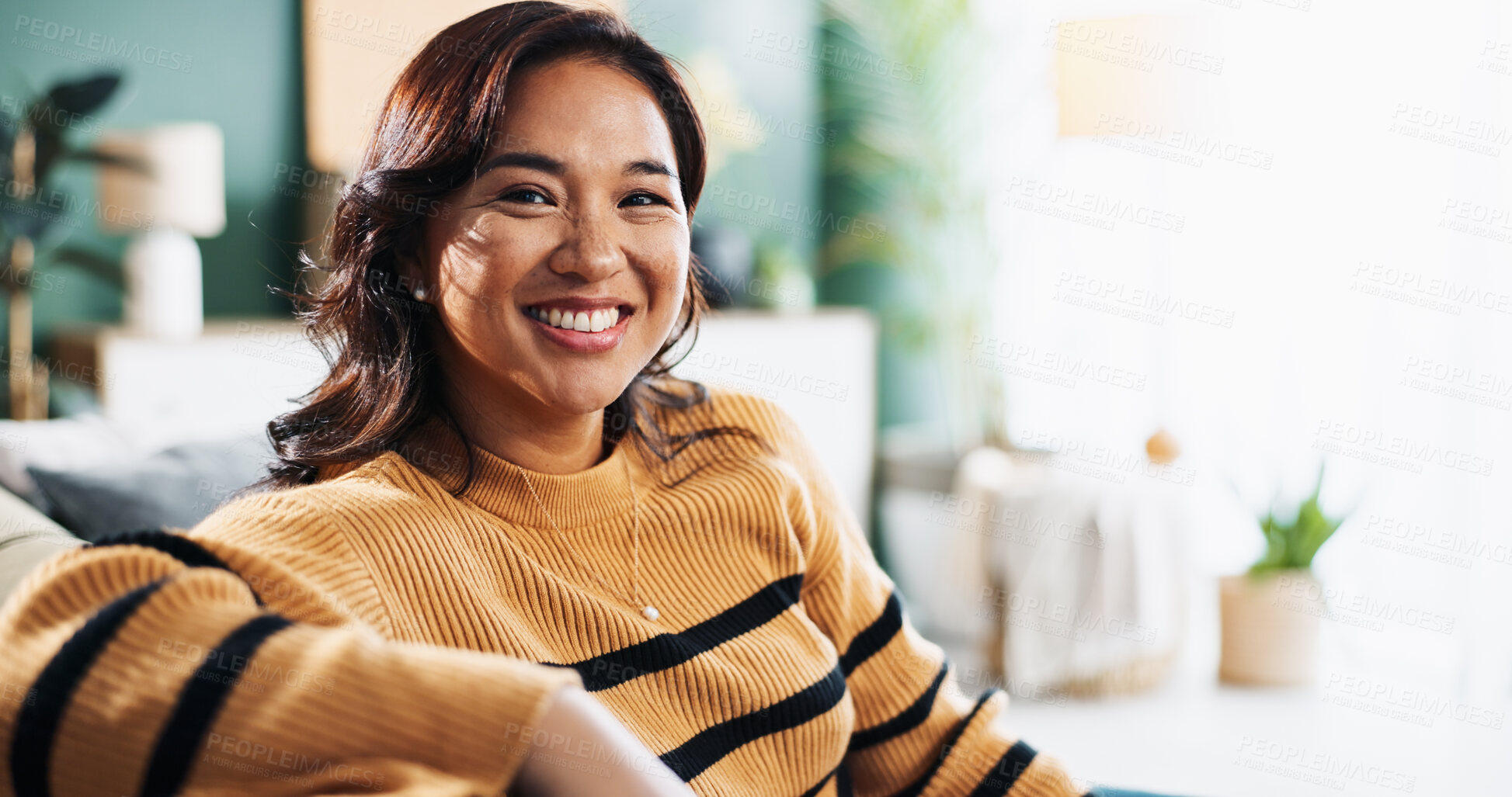 Buy stock photo Portrait, relax and happy Asian woman in home for peace and calm on weekend in lounge. Face, smile and female person in living room with comfort, resting and chill on sofa in apartment in Indonesia