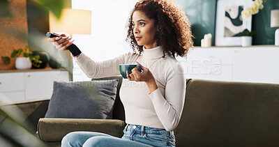 Buy stock photo Woman, coffee and watching tv with remote on sofa for entertainment, show or series at home. Female person, relax and online streaming for movie with caffeine, drink or beverage on couch at house