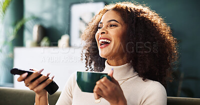 Buy stock photo Home, watching tv and woman on sofa, coffee and funny with weekend break, humor and relax. Apartment, remote control and happy person on couch, laughing and joke with happiness, smile and cappuccino