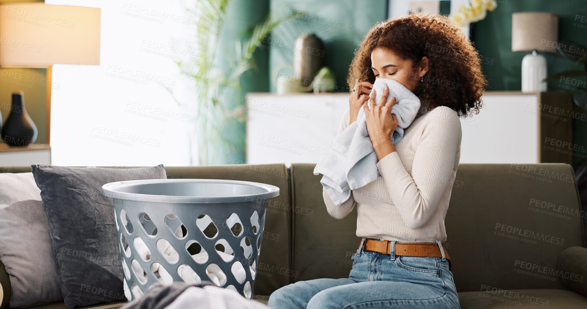 Buy stock photo Laundry, woman and smell clothes in home for fresh scent, detergent fragrance and clean linen. Washing basket, housewife and towel aroma on sofa for housekeeping, domestic chores and packing fabric