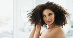 African woman, afro and hair care by bathroom mirror with smile for grooming, growth and volume in home. Person, morning and happy with routine for hairstyle, results and curly texture at apartment