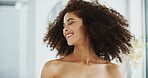 African woman, morning and curly hair in bathroom with smile for grooming, growth and volume in home. Shampoo, shake and happy person with confidence, cosmetics results or afro texture for beauty