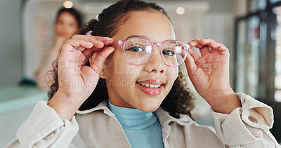 Buy stock photo Optometry store, kid and portrait with glasses for optical correction, vision or frame shopping. Happy girl, customer and eyewear fitting for size, eye care prescription or healthcare service in shop