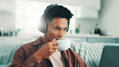 Buy stock photo Coffee, headphones and laptop with man on sofa in living room of home for time off or weekend streaming. Computer, morning and relax with person drinking fresh caffeine beverage from cup in apartment