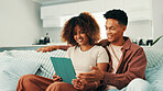 Tablet, smile and couple on sofa in home with planning romantic vacation, holiday or getaway. Happy, digital technology and man with woman for booking flights for honeymoon trip in apartment.