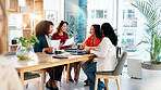 Women, meeting and document with team at office, brainstorming and review with problem solving at startup. Business people, paperwork and happy with report, proposal and feedback at creative agency