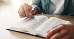 Hands, bible study and religion with reading in home for spiritual guide, wisdom and faith in morning. Christian person, book and holy scripture for connection to God, knowledge and praise at house