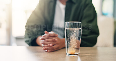 Buy stock photo Hands, table and water with pill, dissolve and supplement with vitamin B in liquid, nutrients and home. Healthcare, desk and person with medicine in glass, bubbles or wellness benefits of antibiotics