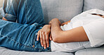 Woman, rest or hands on stomach with pain, menstruation cramps or IBS symptoms in home. Person, discomfort or relax on sofa with period, tummy ache or bloating with celiac complication in living room