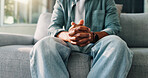 Hands together, psychology and woman on sofa, stress and trauma counselling with depression. Closeup, therapy room and person on couch, body language and mental health with emergency, worry or crisis