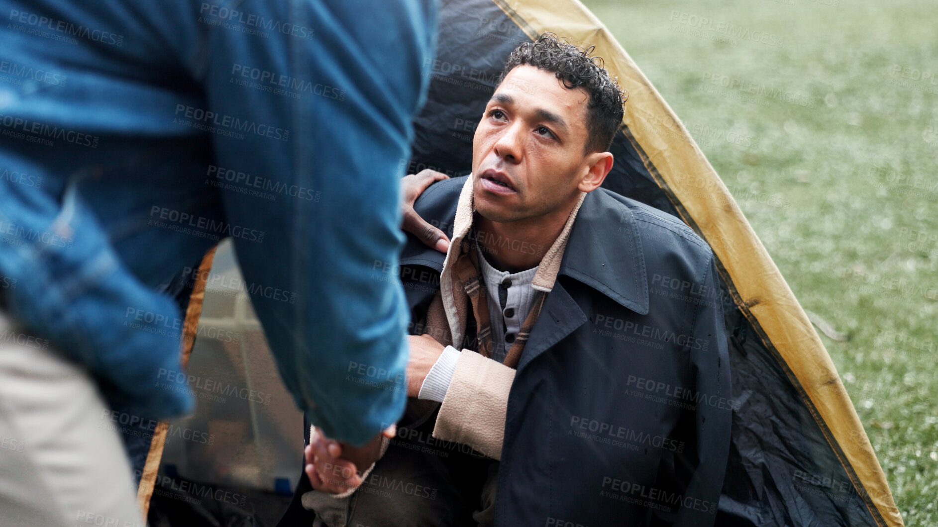 Buy stock photo Homeless, poor and handshake with person for help with donation, compassion and empathy for struggle. Tent, beggar and shaking hands for assistance, blessing and charity with vulnerability outdoor