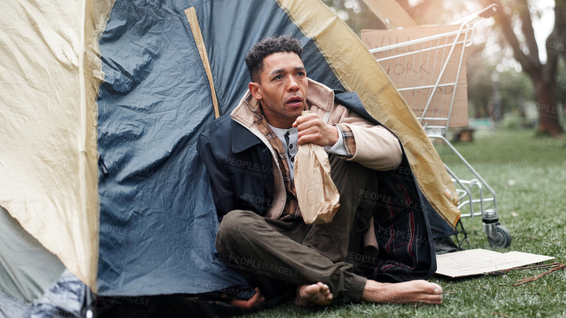 Buy stock photo Man, poverty and outdoor with alcohol, homeless and tent with addiction, thinking and perspective on ground. Person, bottle and sad with reflection for grief, bankrupt and poor with stress in Brazil