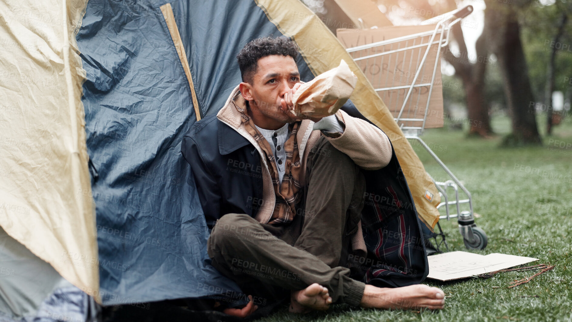 Buy stock photo Man, poverty and outdoor with alcohol, drink and tent with addiction, thinking and perspective on ground. Homeless person, bottle and reflection with grief, bankrupt and poor with stress in Brazil
