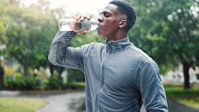 Buy stock photo Drinking water, outdoor and black man with fitness, healthy guy and exercise with thirsty. African person, athlete and runner in street, bottle and liquid with wellness, hydration and sports in park