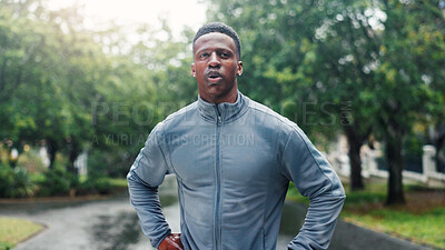 Buy stock photo Fitness, man and tired with resting at park for running fatigue, workout recovery and cardio challenge. Runner, black person and breathing in road with marathon break, exhausted or dedication in rain