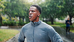 Fitness, man and rest with breathing at park for marathon fatigue, running recovery or endurance challenge. Athlete, black person and tired in rain with workout break, exercise performance or burnout