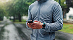 Nature, smartphone and hands of man with fitness routine on mobile app for outdoor training with workout. Cellphone, park and male athlete with technology for networking on cardio exercise in morning