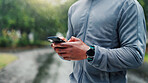 Park, phone and hands of man with fitness routine on mobile app for outdoor training with workout. Cellphone, nature and male athlete with technology for networking on cardio exercise in morning.