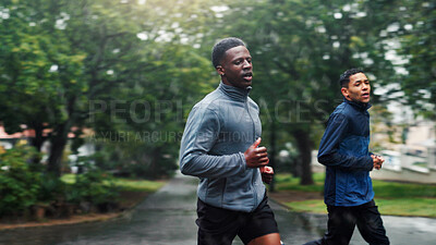 Buy stock photo Fitness, rain and men running in road for marathon training, endurance and discipline with cardio exercise. Friends, teamwork and runner club with workout, sports challenge and morning jog in nature
