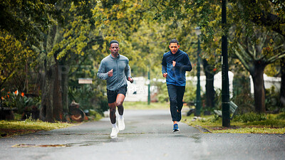 Buy stock photo Workout, rain and men running in road for marathon training, endurance challenge and discipline with cardio exercise. People, teamwork and runner club with race, morning jog and wellness in nature
