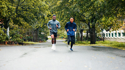 Buy stock photo Athlete, fitness and men running in road for marathon training, endurance and discipline with cardio challenge. Friends, teamwork and runner club with healthy workout, morning jog or exercise in rain