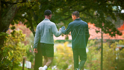 Buy stock photo Fitness, athlete and men with fist bump, outdoor or celebration for finished workout or wellness. Back, personal trainer and people with gesture for success of exercise, healthy or together in nature