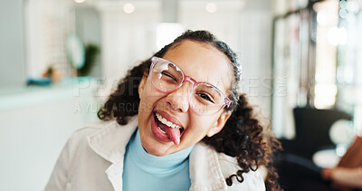 Buy stock photo Funny face, child and glasses for optometry in portrait with tongue out, playful and goofy wink. Girl, kid and happy at optician store with frame, lens and silly with eyewear for vision or eye care