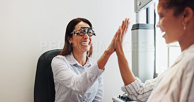 Buy stock photo Eye care, high five or optometry with woman in clinic with diagnostic tool for prescription lens. Happy client, glasses or optometrist in vision assessment with smile, eyesight success or support