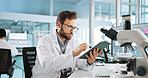 Scientist, man and tablet for study at laboratory with feedback, review and medical notes for pharma job. Person, typing and equipment with application for vaccine, development and clinical trial