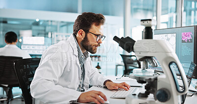 Buy stock photo Microscope, computer and research with man in laboratory for tissue sample, cancer cure and healthcare. Cell treatment, report and medical test with person in clinic for tumor enzyme and record