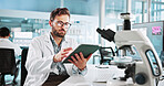 Scientist, man and research with tablet at lab with writing, review and medical notes for pharma job. Person, gloves and equipment with application for vaccine development, trial and clinical study