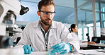 Scientist, man and chemical with microscope for research, breakthrough or medical analysis. Biotech, laboratory and solution with DNA for pharmaceutical RNA study or chemistry experiment project
