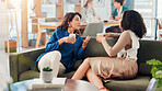 Sofa, business women and discussion on coffee break for planning project and meeting. Team, talking and colleagues in company lounge for brainstorming ideas, drink and listening to story in office