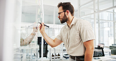 Buy stock photo Business, glass wall and man with creativity, writing and planning with ideas for proposal. Person, employee and sales consultant in workplace, problem solving and brainstorming for project or choice