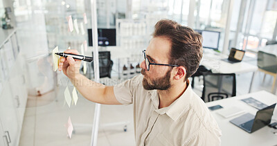 Buy stock photo Businessman, writing or planning with glass board for schedule, agenda or tasks at office. Man, employee or planner with sticky note for brainstorming strategy, project ideas or reminder at workplace