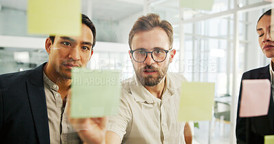 Buy stock photo Business, people and writing on sticky notes by glass wall for campaign planning, brand management and teamwork. Marketing manager, employees and creative strategy for ROI monitor or deadline planner