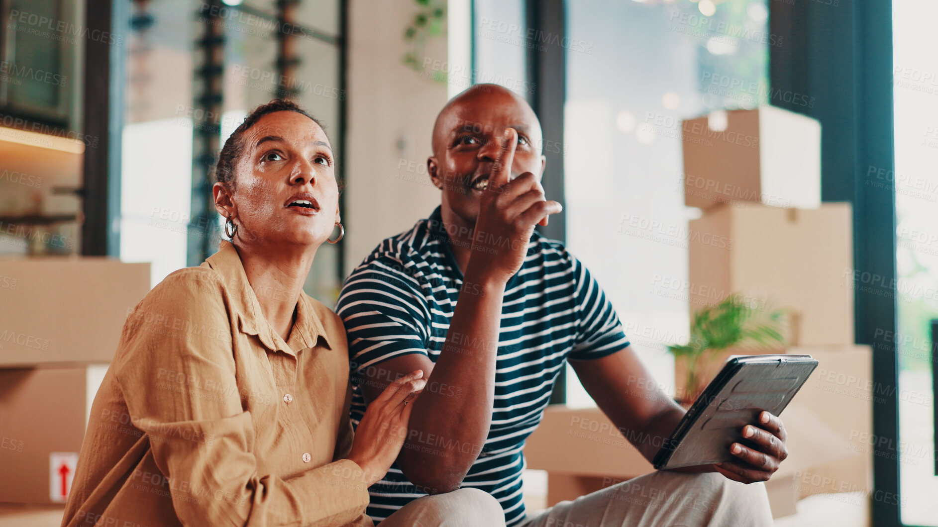 Buy stock photo New home, property and couple with tablet, boxes and conversation for renovation. African man, apartment and woman with discussion, real estate or moving house with digital app for planning or talk