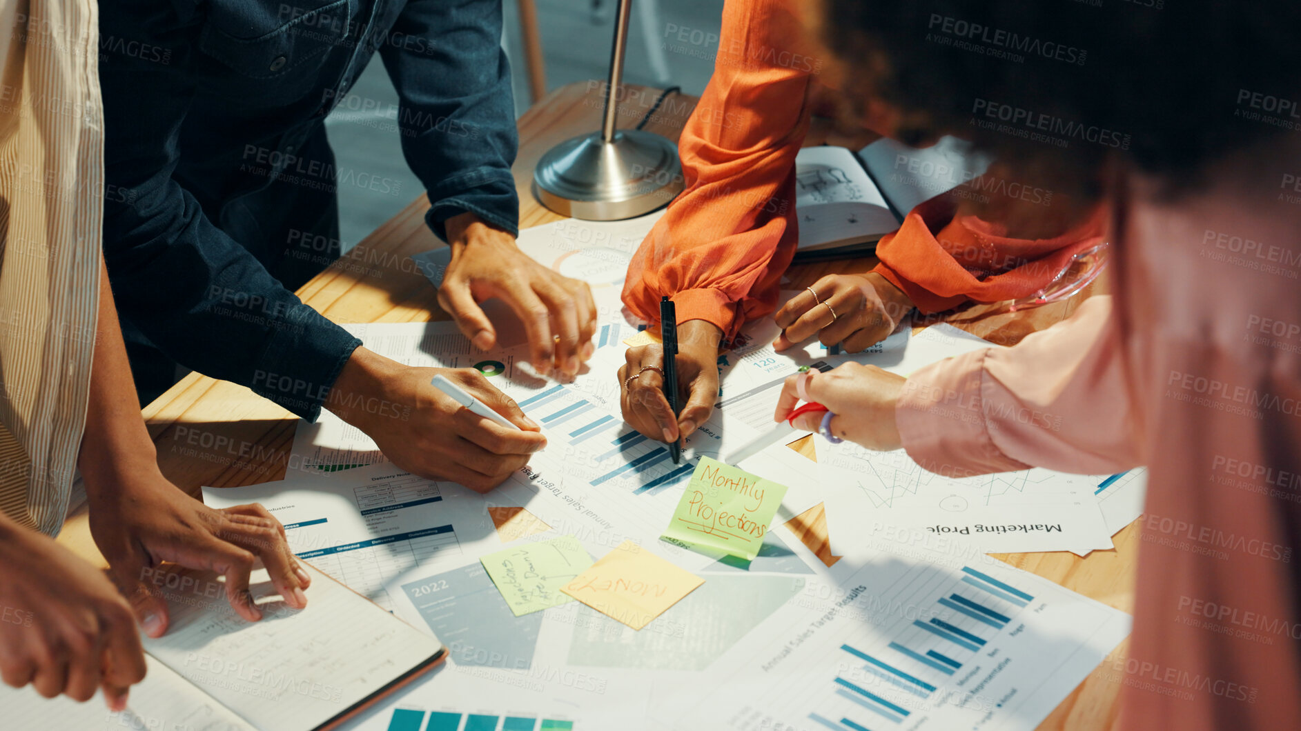 Buy stock photo Hands, graphs and group of business people planning strategy, performance analysis and writing on paper. Charts, documents and collaboration with financial stats, revenue and profit in office above