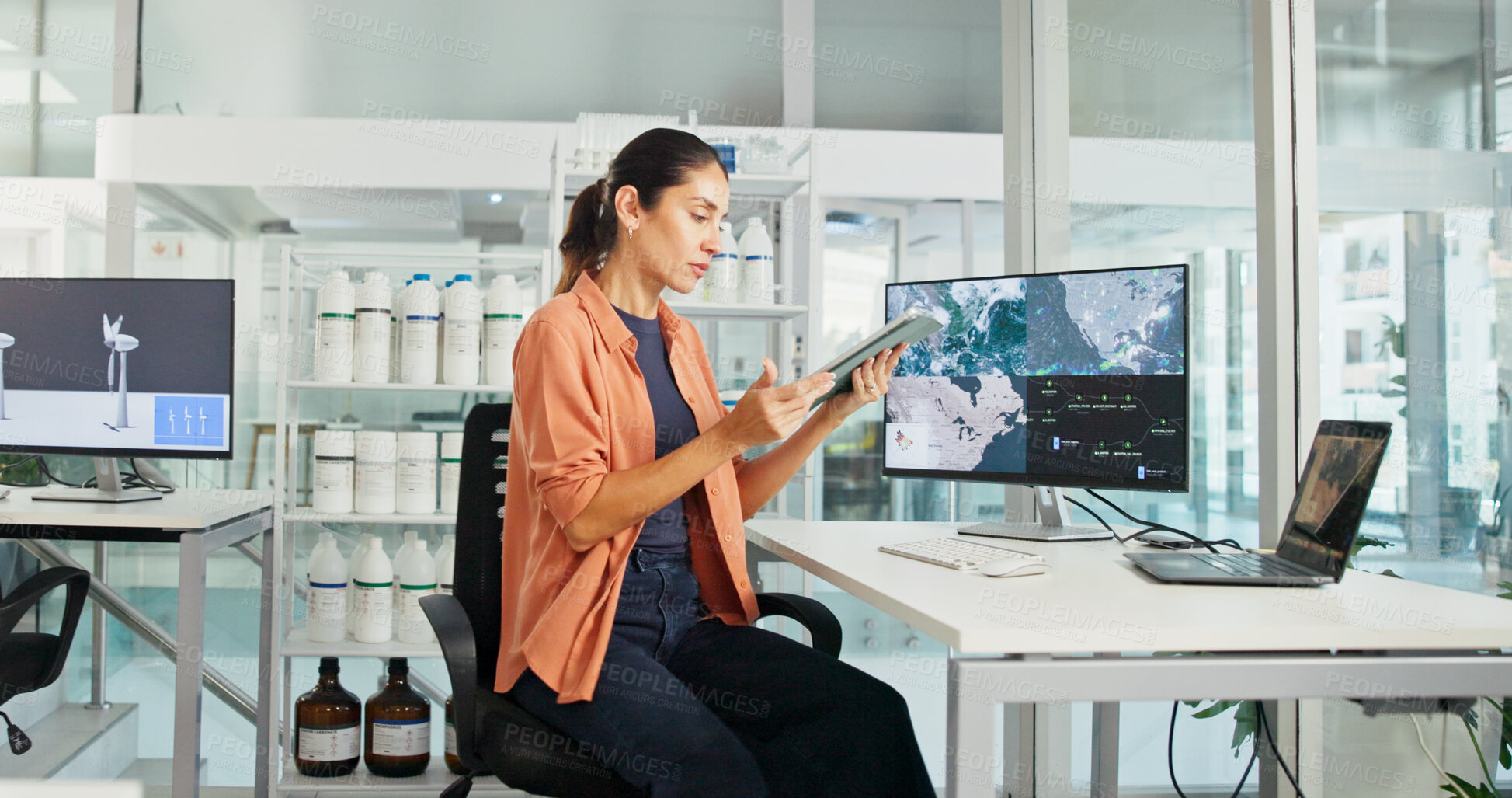 Buy stock photo Computer screen, tablet and windmill with business woman in office for renewable energy or sustainability. Electricity, industry and wind turbine with map on display for development or engineering