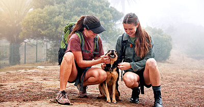 Buy stock photo Girl, hiking and friends with dog in nature for memory, laugh and happy for tourism in countryside. People, women and pet animal with love with bonding, stroke and outdoor on trail at park in England