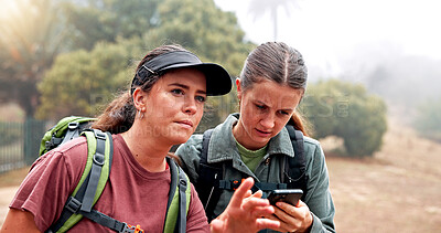 Buy stock photo Hiking, phone and women on mountain search for navigation, direction and digital map for journey. Travel, friends and people on smartphone for location, trail and trekking on adventure in nature