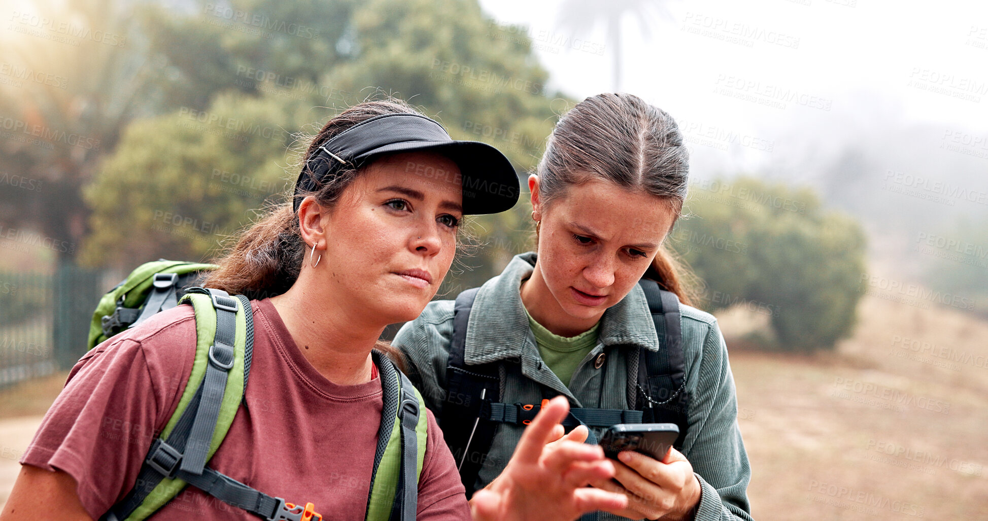 Buy stock photo Hiking, phone and women on mountain search for navigation, direction and digital map for journey. Travel, friends and people on smartphone for location, trail and trekking on adventure in nature