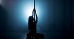 Woman, dancing or pole with spotlight for silhouette, tease performance or sexy movement in nightclub. Person, dark background or girl in stage routine for seduction, strip or party entertainment