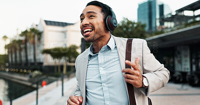 Buy stock photo Businessman, happy and dancing outdoor with headphones for morning commute, audio playlist or streaming music. Professional, person and walking in city with sound track, radio and travel to new job