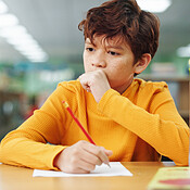 Boy, education and writing with thinking at library for test, study or ...