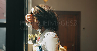 Buy stock photo African woman, window and regret in home with headache, mistake or anxiety with reflection for decision. Person, sad and thinking for perspective, loss or grief with mental health in morning at house