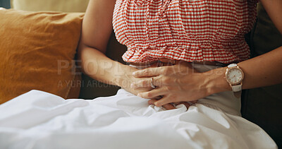 Buy stock photo Woman, hands and pain with stomach ache on sofa for diarrhea, gastrointestinal disease or reflux at home. Closeup, person or sick with belly cramp or indigestion for nausea, illness or menstruation