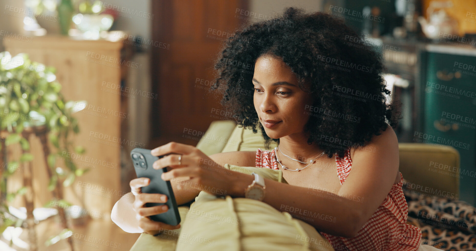 Buy stock photo Phone, relax and African woman on sofa in home for social media, networking and communication. Apartment, living room and person on smartphone for online chatting, internet post or website on weekend